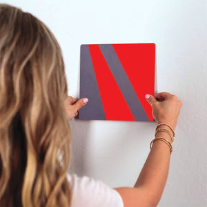 Gray and Red Rays Slidetile on wall in office.