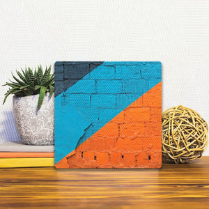 A Slidetile of the Orange and Blue on Brick sitting on a table.