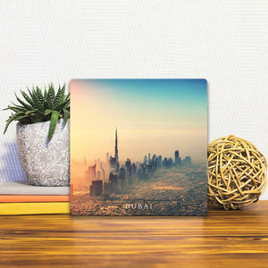 A Slidetile of the Dubai Skyline sitting on a table.
