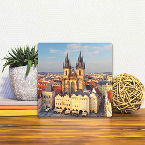 A Slidetile of the Old Town Sqaure in Prague sitting on a table.