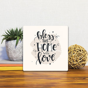 A Slidetile of the Bless this home sitting on a table.
