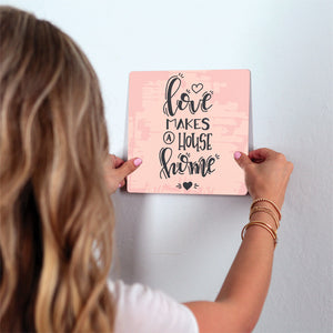 Love makes a house home Slidetile on wall in office.