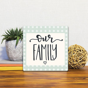 A Slidetile of the Our Family sitting on a table.