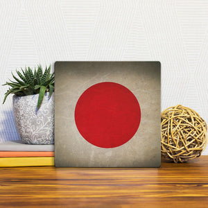 A Slidetile of the The Japanese Grunge Flag sitting on a table.