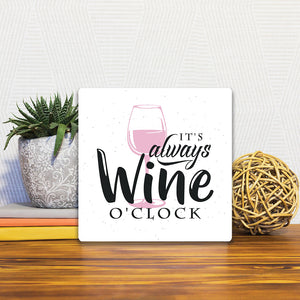 A Slidetile of the It&#39;s Always Wine O&#39;Clock sitting on a table.