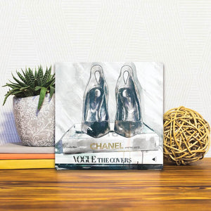 A Slidetile of the Beauty Books and Shoes sitting on a table.