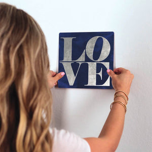 Love on Blue Slidetile on wall in office.