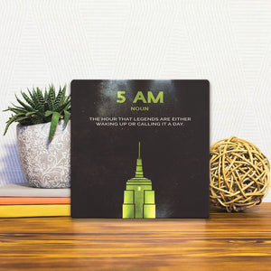 A Slidetile of the Definition of 5am sitting on a table.