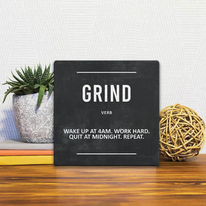 A Slidetile of the Definition of Grind sitting on a table.