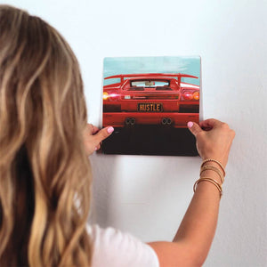 Lambo Hustle Slidetile on wall in office.