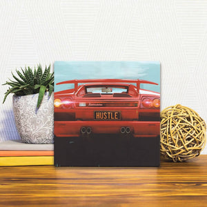 A Slidetile of the Lambo Hustle sitting on a table.