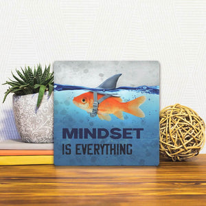 A Slidetile of the Mindset is Everything sitting on a table.