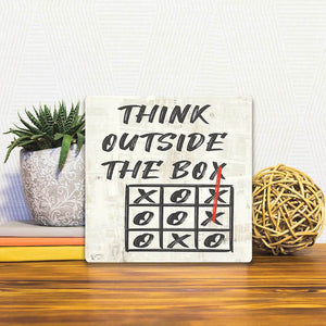 A Slidetile of the Always Think Outside the Box sitting on a table.