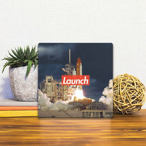 A Slidetile of the Time to Launch sitting on a table.