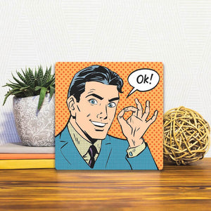 A Slidetile of the A OK! sitting on a table.