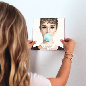 Hepburn Blows a Bubble Slidetile on wall in office.