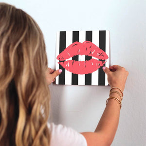 Kiss Me Slidetile on wall in office.