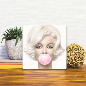 A Slidetile of the Monroe Blows a Bubble sitting on a table.