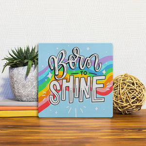 A Slidetile of the Born to shine sitting on a table.
