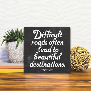 A Slidetile of the Difficult Roads sitting on a table.