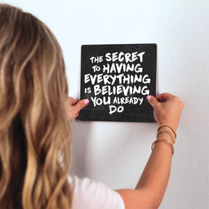 The secret to having everything… Slidetile on wall in office.
