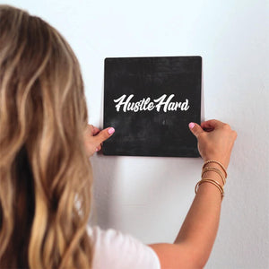 Hustle Hard Slidetile on wall in office.