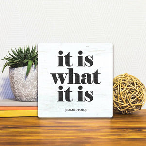 A Slidetile of the It Is What It Is sitting on a table.