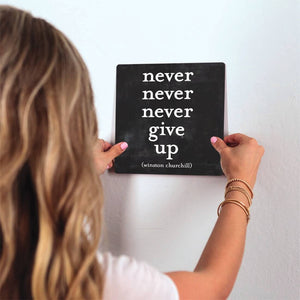 Winston Churchill - Never give up Slidetile on wall in office.