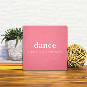 A Slidetile of the Dance as though no one is watching sitting on a table.