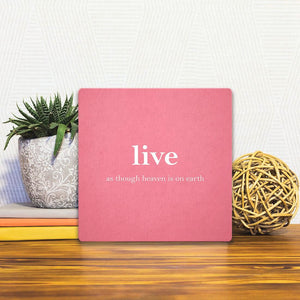 A Slidetile of the Live as though heaven is on earth sitting on a table.
