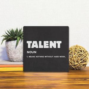 A Slidetile of the The Definition of Talent sitting on a table.