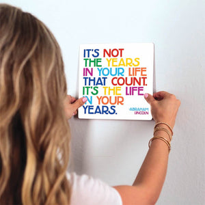 It's not the years in your life… Slidetile on wall in office.