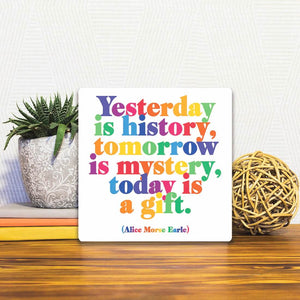 A Slidetile of the Today is a gift… sitting on a table.