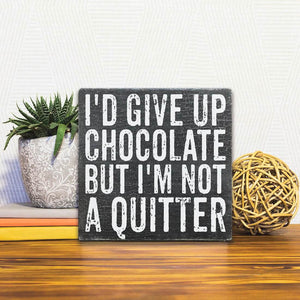 A Slidetile of the I'd Give Up Chocolate But… sitting on a table.
