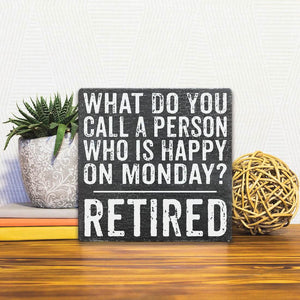 A Slidetile of the Who is Happy on Monday? sitting on a table.