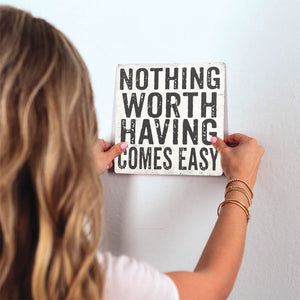 Nothing Comes Easy Slidetile on wall in office.