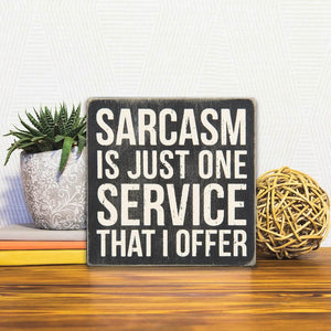 A Slidetile of the I Offer Sarcasm sitting on a table.