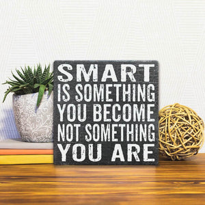 A Slidetile of the Smart is Something You Become sitting on a table.
