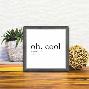 A Slidetile of the Definition of Oh, Cool sitting on a table.