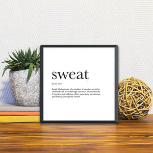 A Slidetile of the Definition of Sweat sitting on a table.