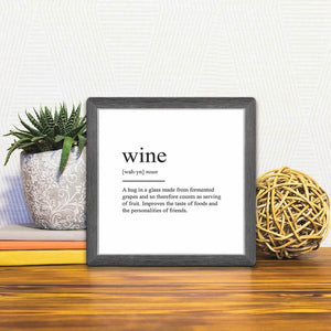 A Slidetile of the Definition of Wine sitting on a table.
