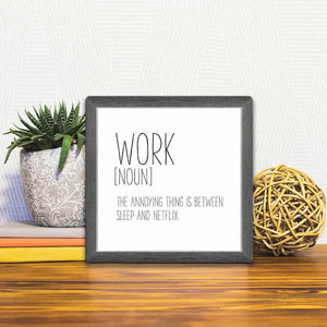 A Slidetile of the Definition of Work sitting on a table.
