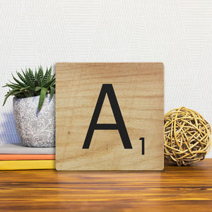 A Slidetile of the Letter A - Light Wood sitting on a table.