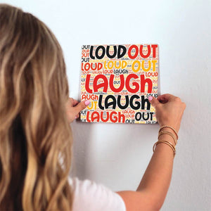 Laugh Out Loud Slidetile on wall in office.