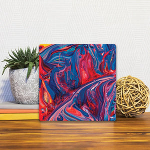 A Slidetile of the Blue and Red Swirl sitting on a table.