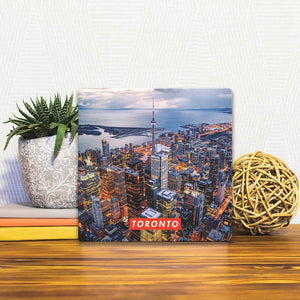 A Slidetile of the Toronto Skyline at Night sitting on a table.