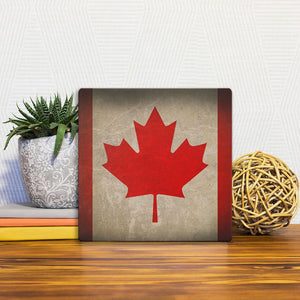 A Slidetile of the The Canada Grunge Flag sitting on a table.
