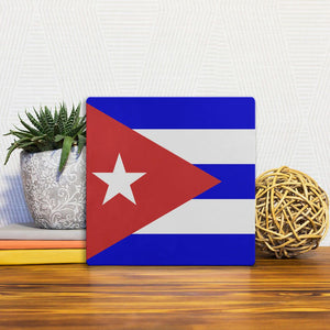 A Slidetile of the The Cuban Flag sitting on a table.