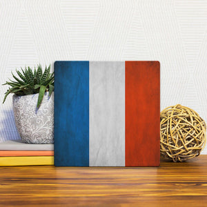 A Slidetile of the The French Grunge Flag sitting on a table.