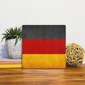 A Slidetile of the The German Grunge Flag sitting on a table.